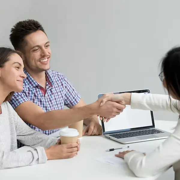 happy-couple-greeting-financial-consultant_1163-4739